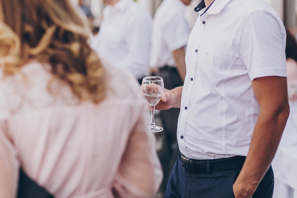 man-holding-champagne-glass-toasting-at-wedding-r-2021-08-28-23-15-14-utc-1