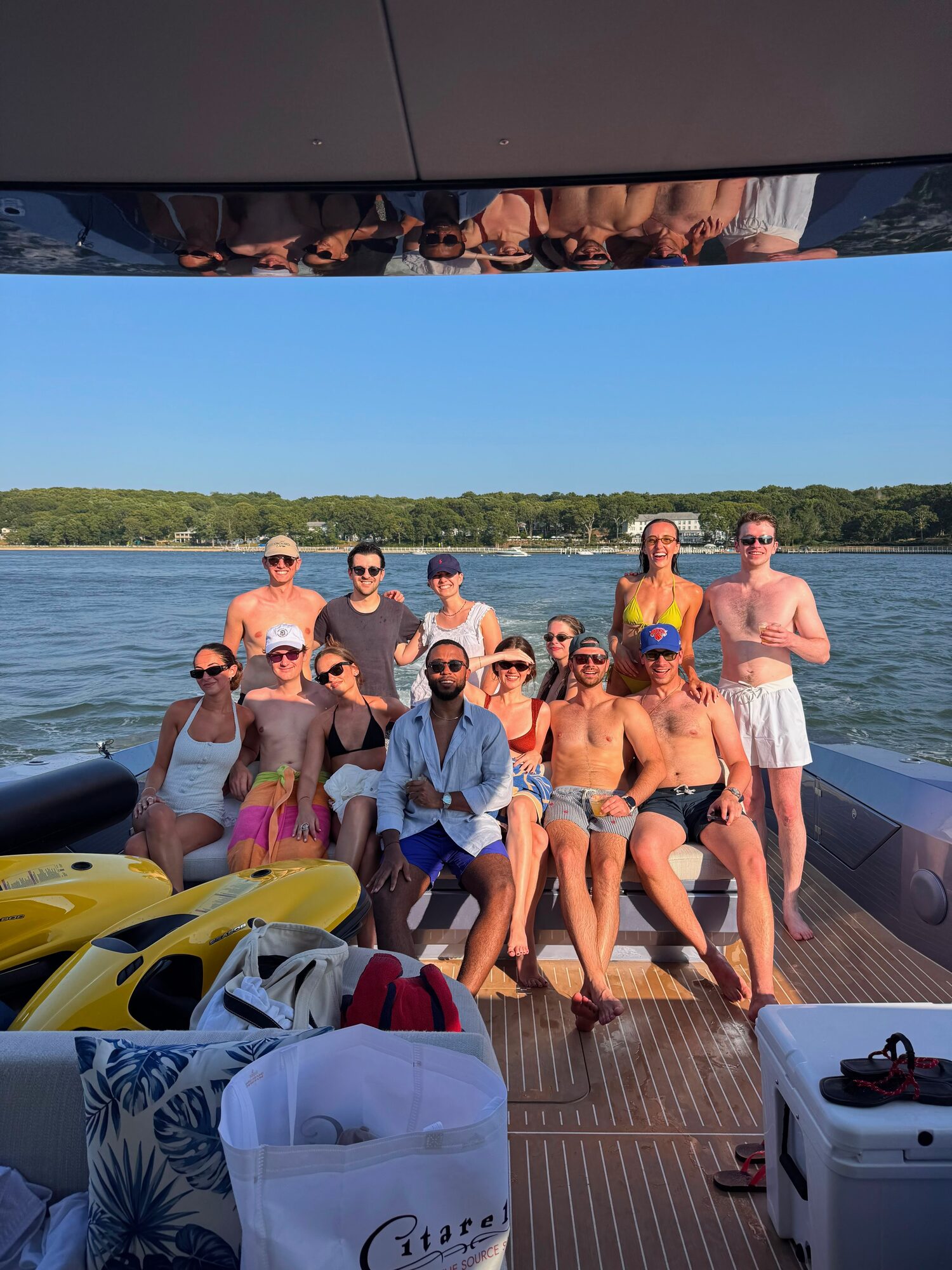 Group on the aft deck with jet skis and water toys at a Hamptons sandbar
