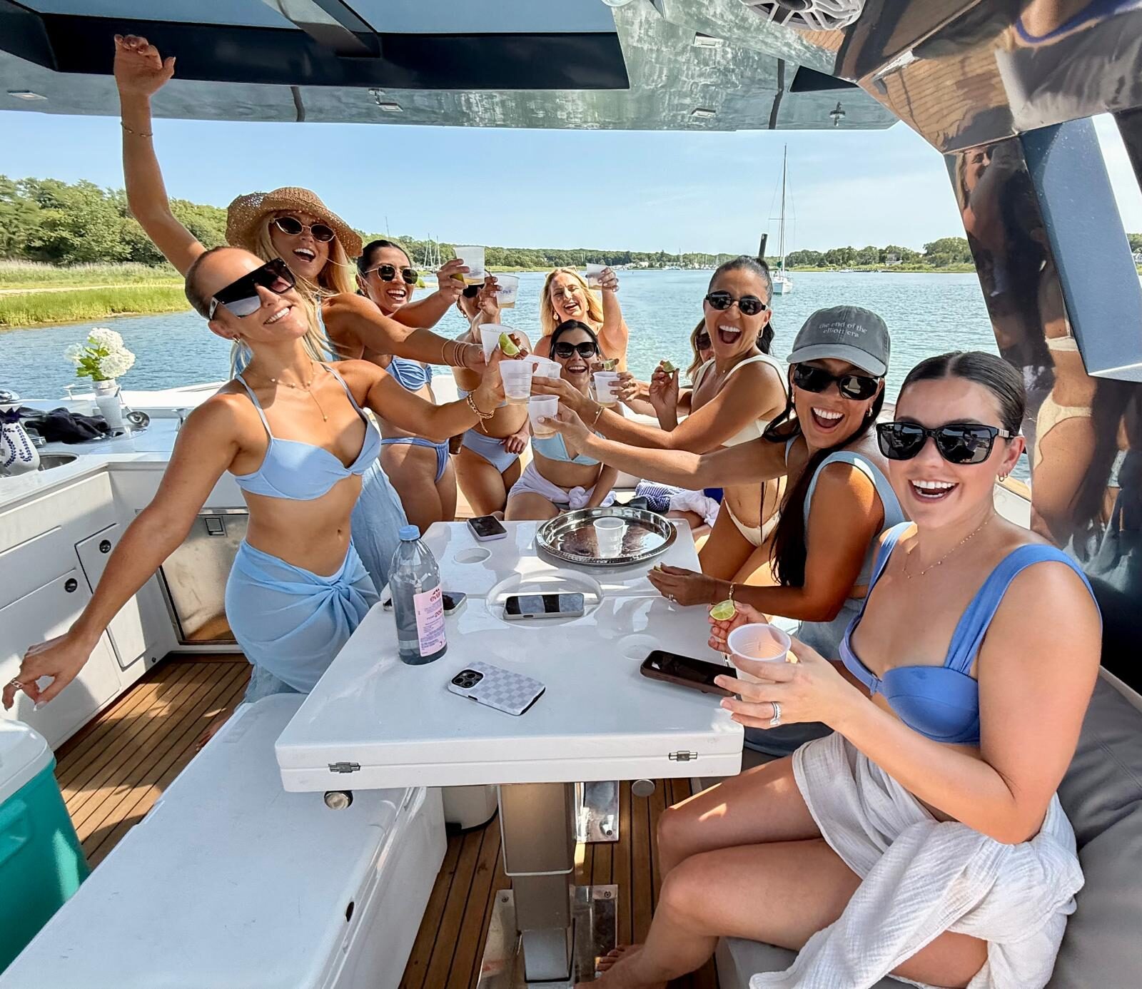 Bachelorette party toasting at the cockpit table on a Hamptons charter