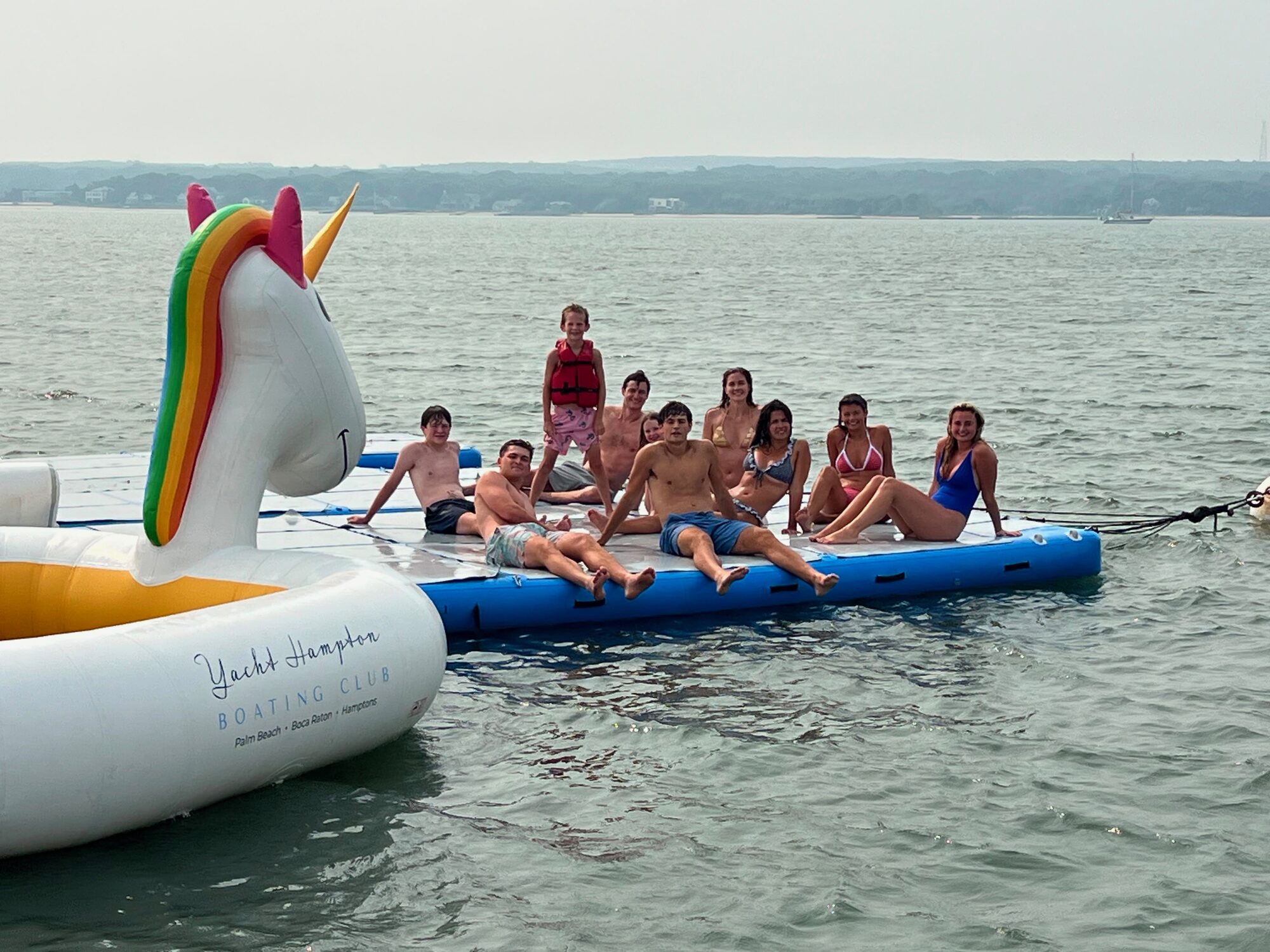 Yacht Hampton Boating Club floating dock and unicorn float at a Hamptons sandbar
