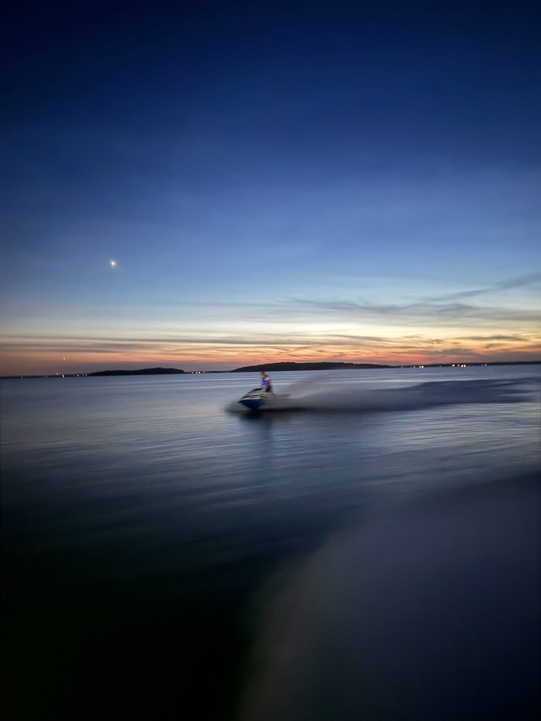 Dusk falling over the bay, seen from the deck of a Yacht Hampton vessel