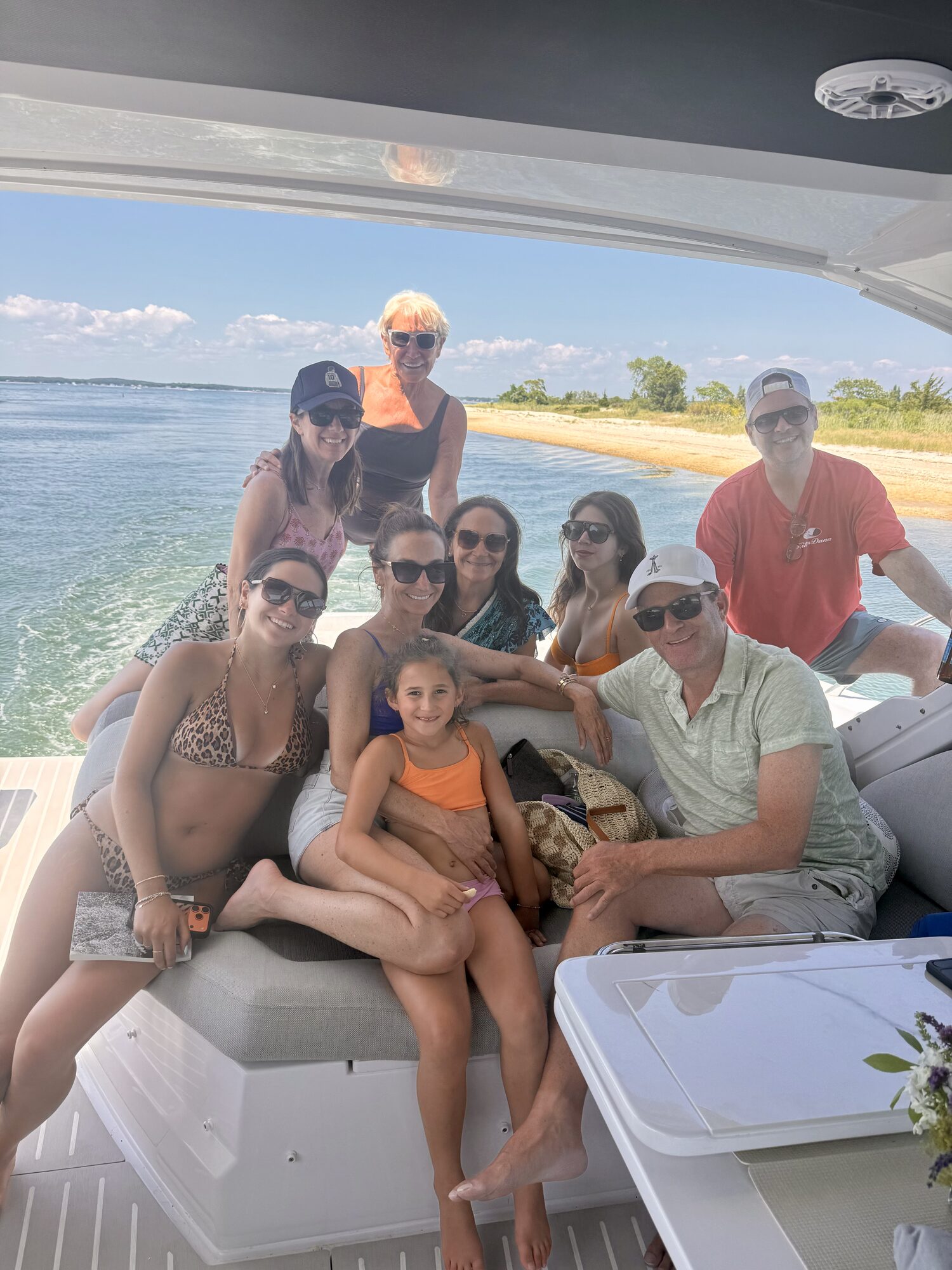 Family gathered on the aft deck anchored off a Hamptons beach