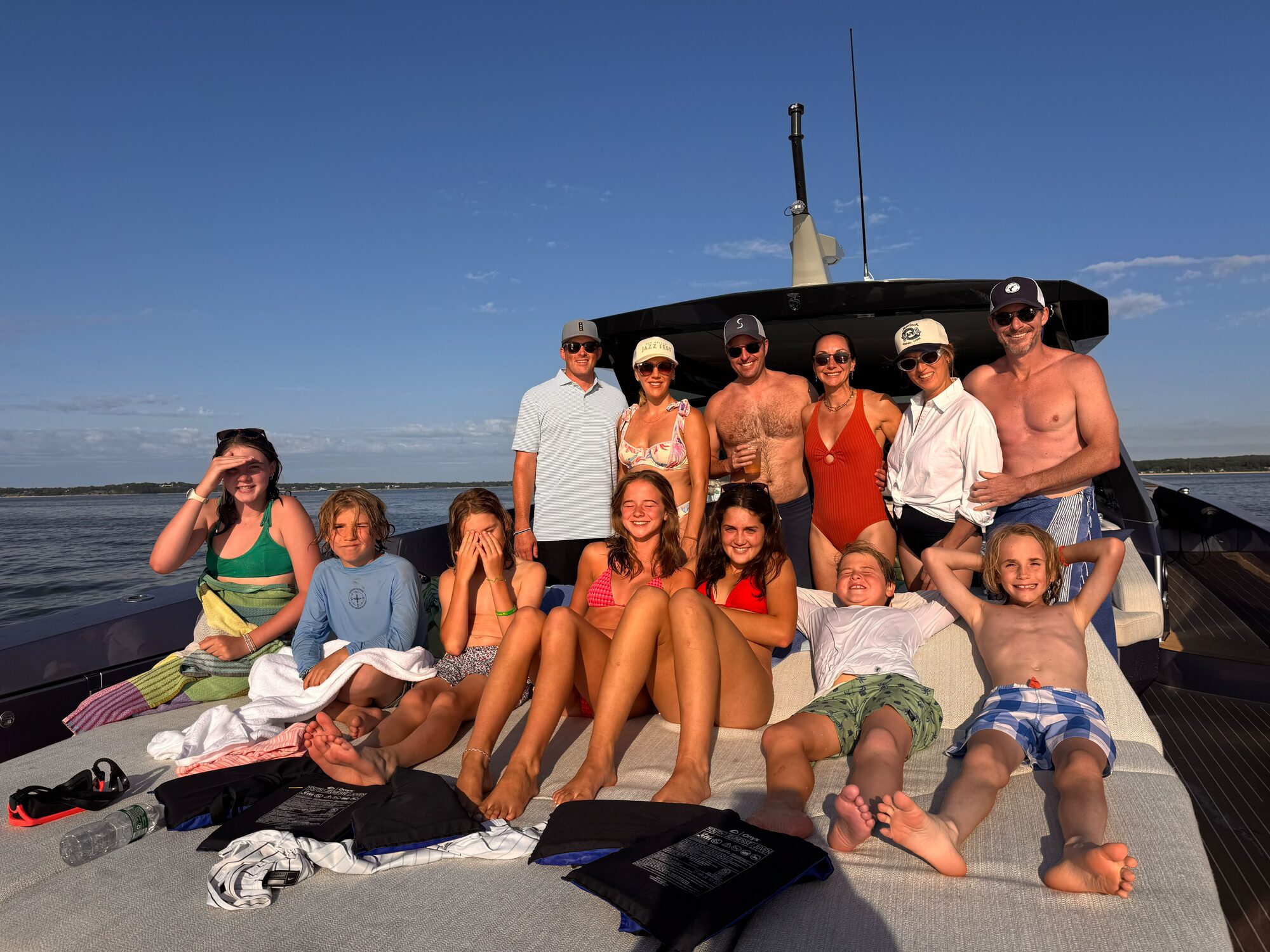 Multi-generational family gathered on the bow at a Hamptons sandbar