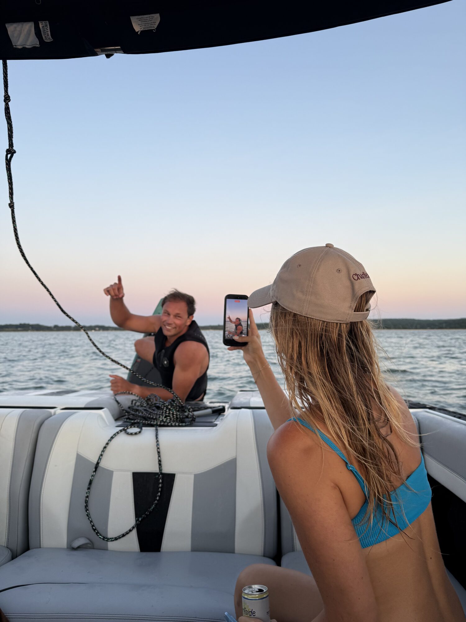 Guests filming at sunset before a wakesurf session