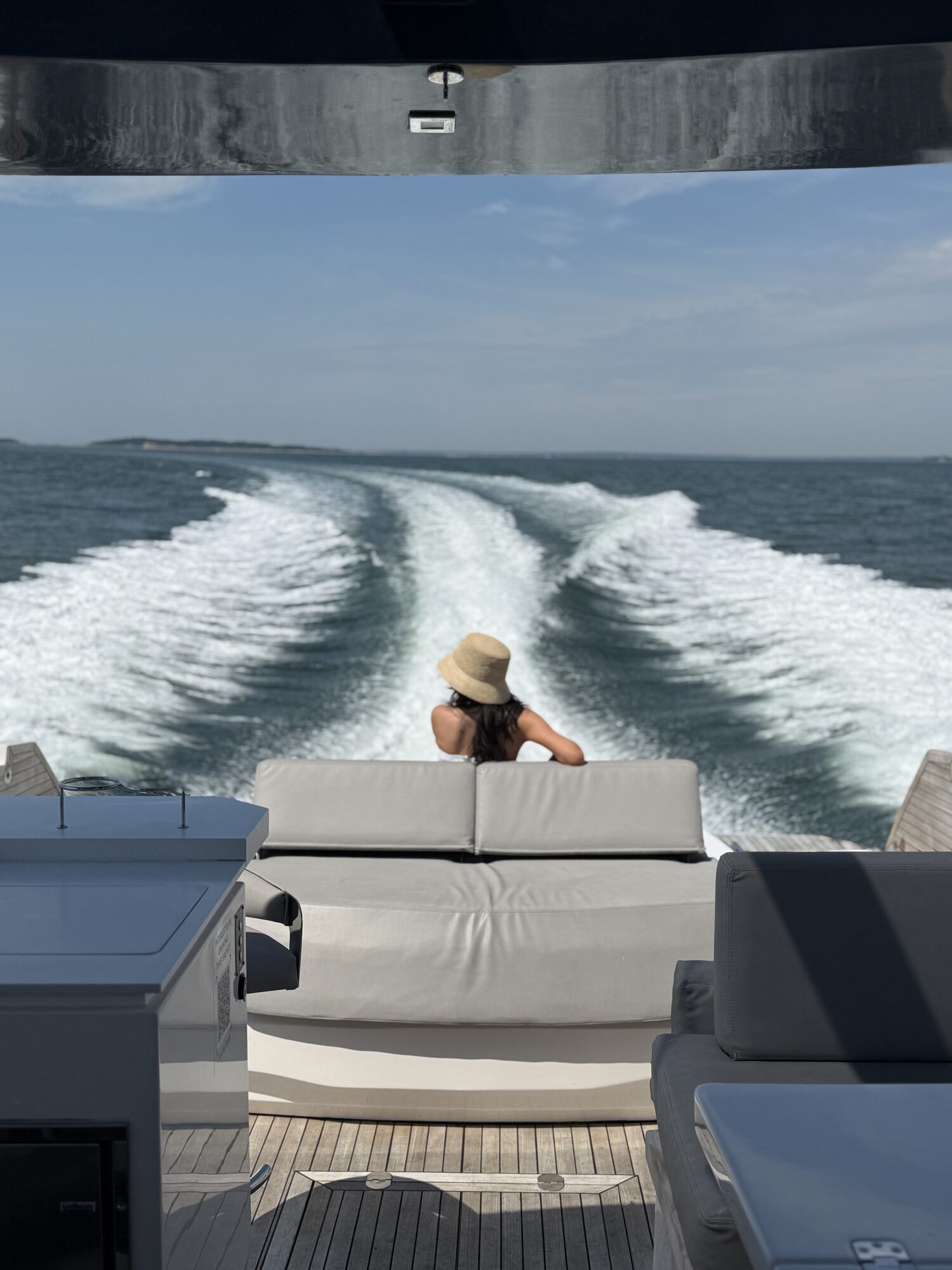 Guest watching the wake from the aft deck