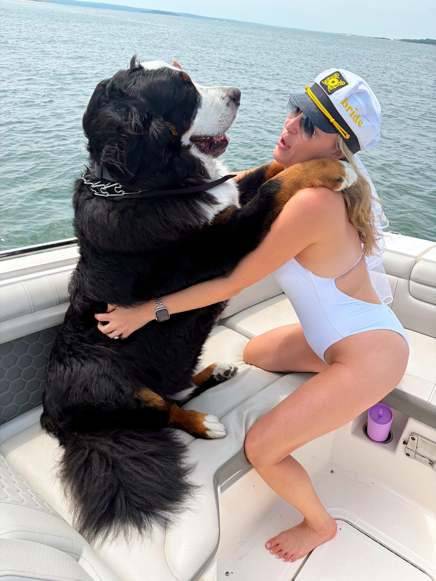 Guest and her Bernese mountain dog relaxing aboard a Hamptons charter