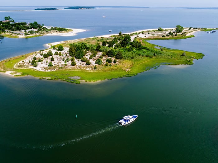 Aerial view of a charter cruising past an island destination