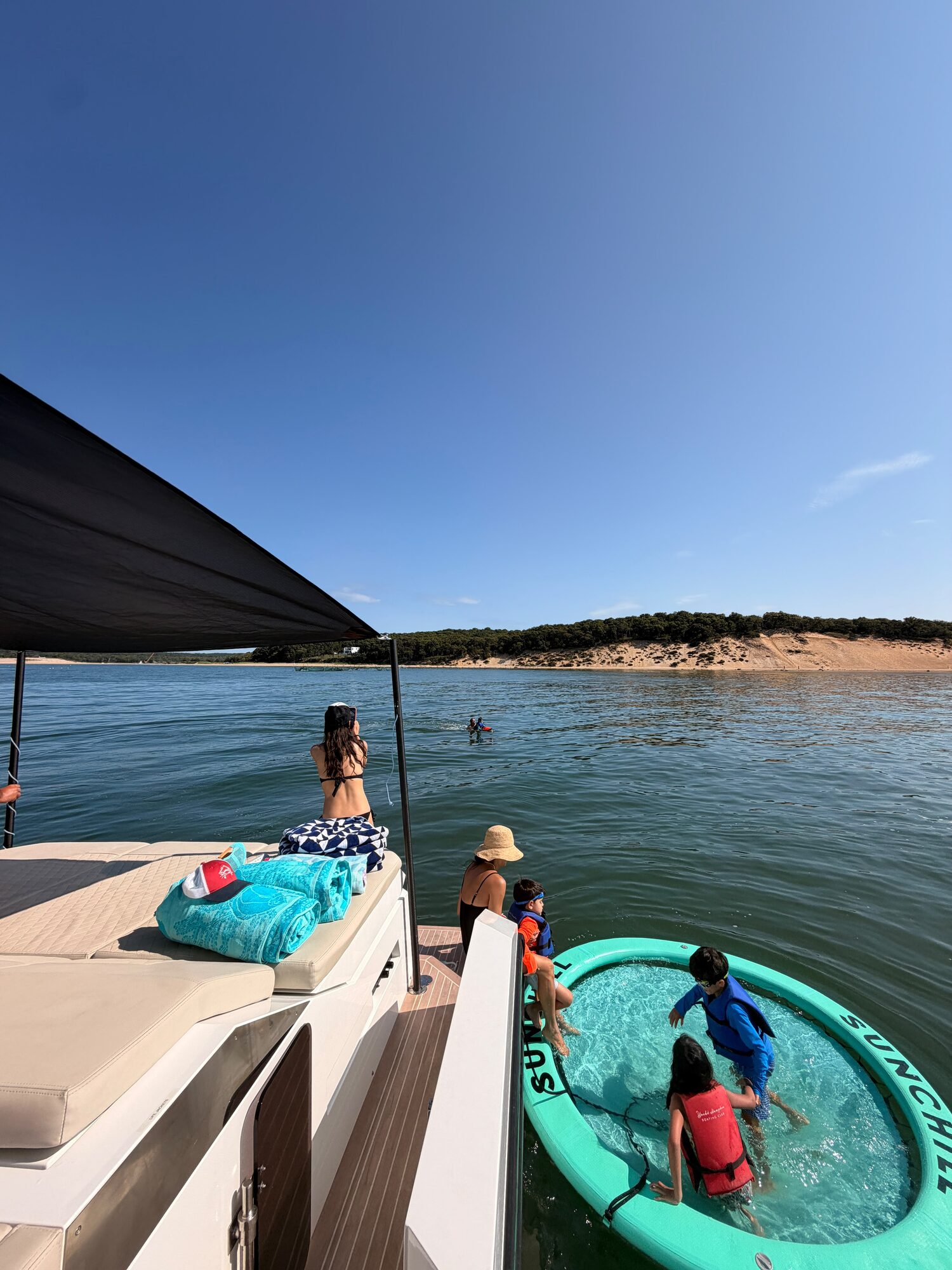 Kids playing in the floating pool off the stern at a Hamptons sandbar