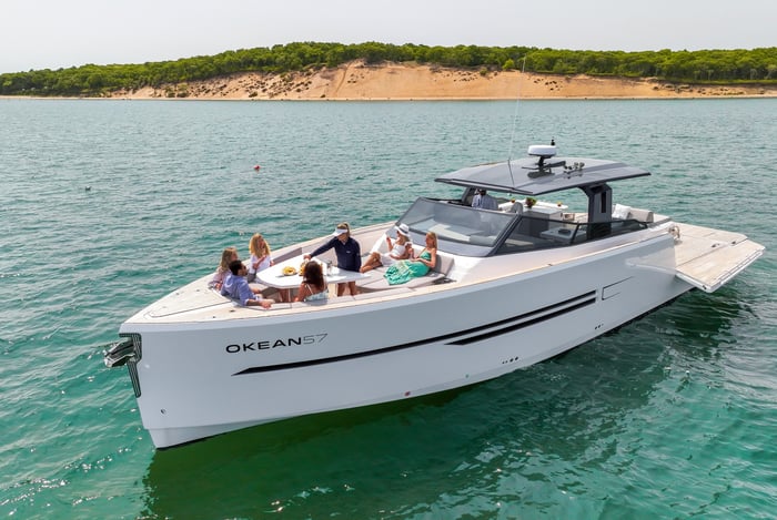 Guests aboard an anchored charter near the dunes