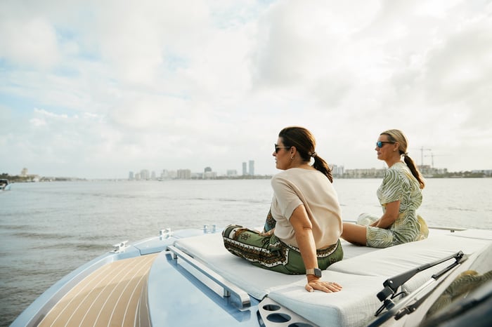 Guests on the bow with the Palm Beaches skyline in the distance