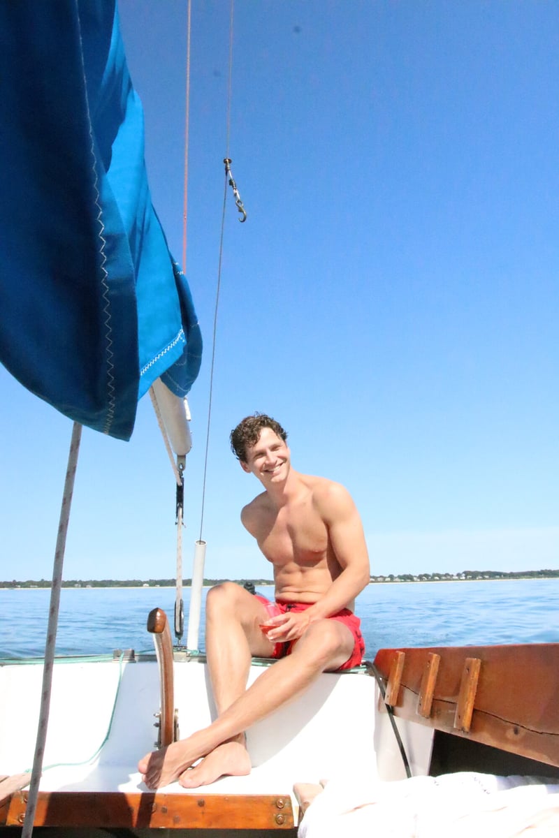Guests relaxing aboard a classic wooden sailboat