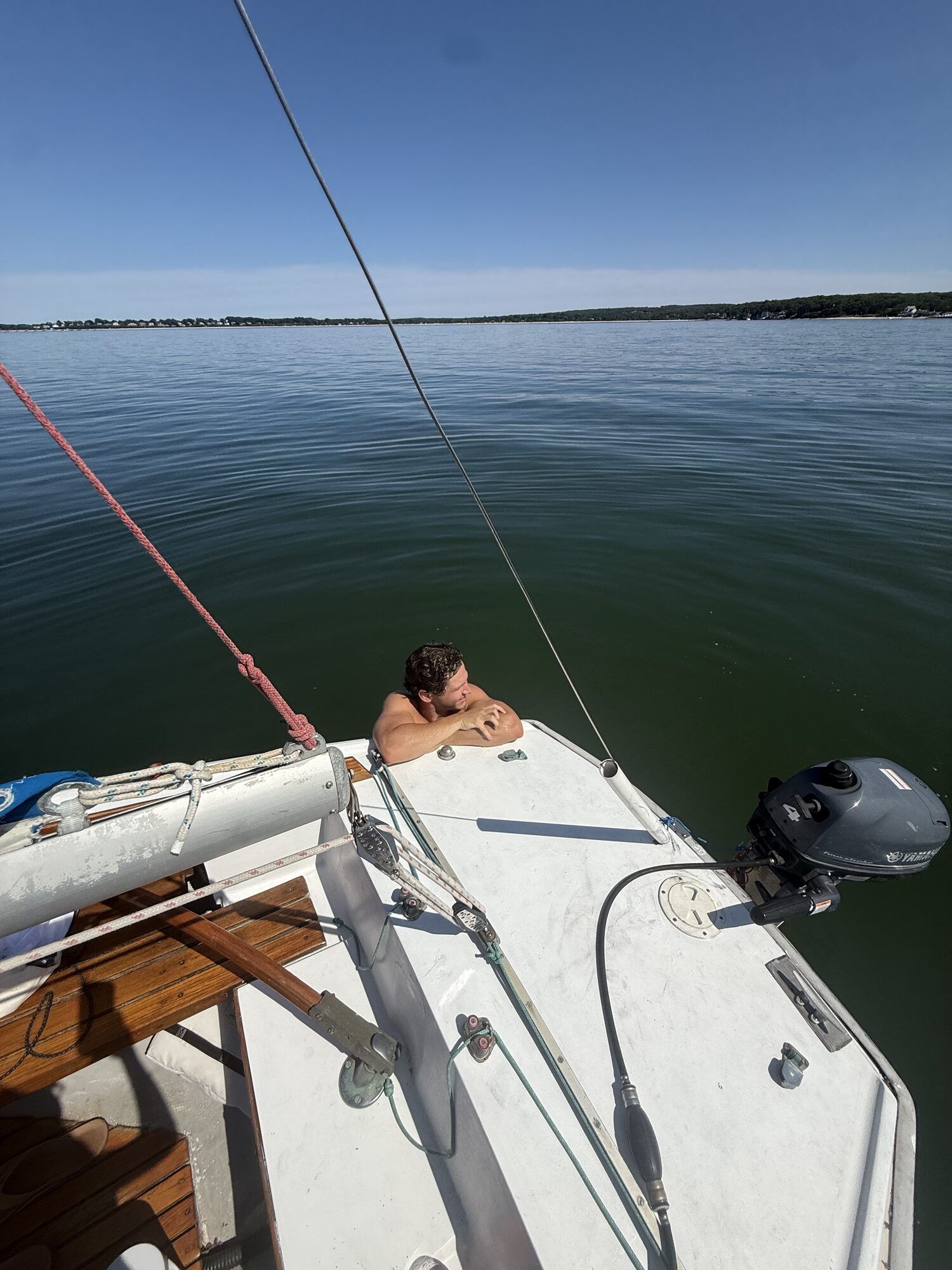 Guest relaxing on the bow of a sailboat in the Hamptons
