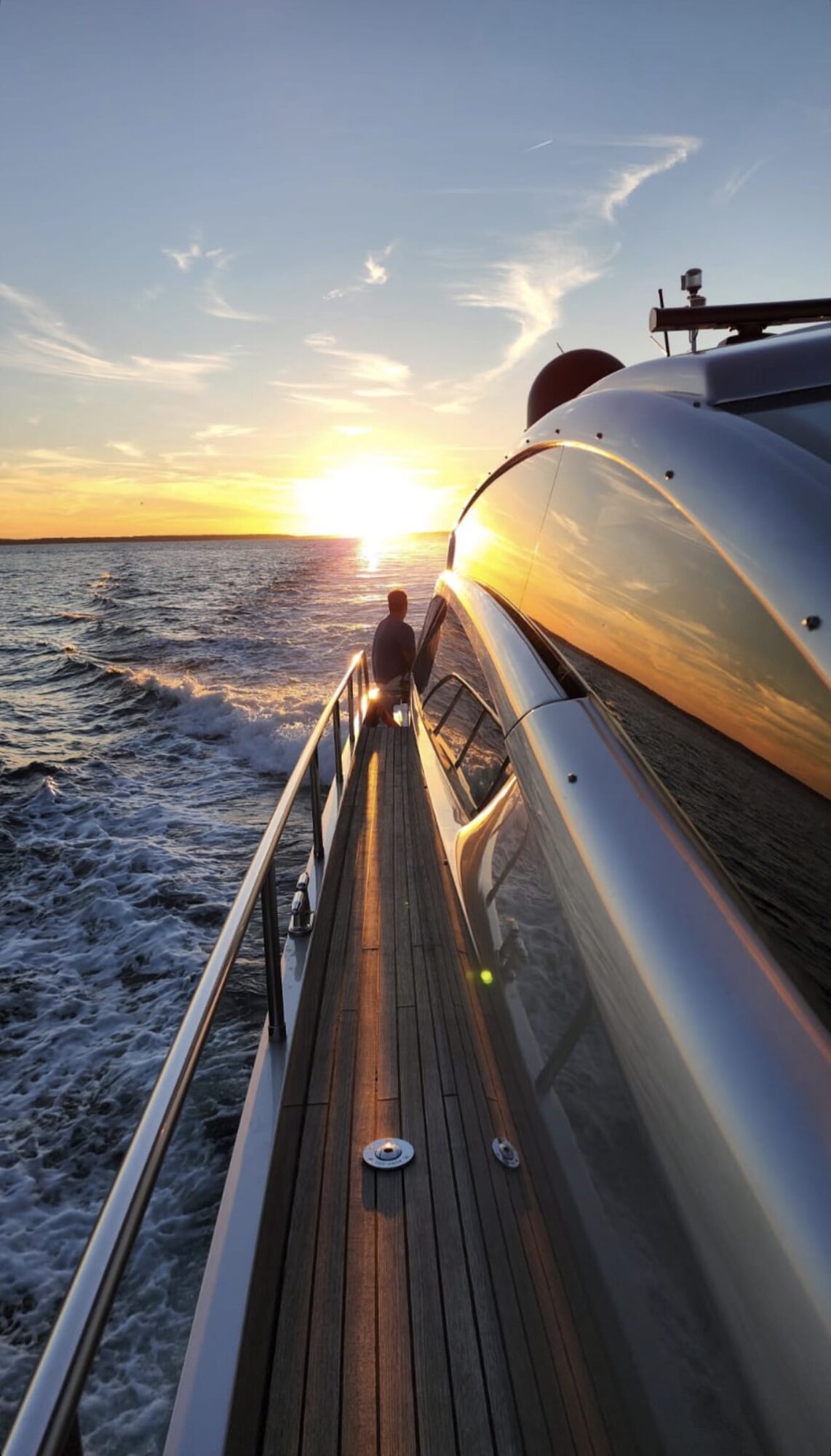 Sunset along the side deck of a Yacht Hampton charter underway