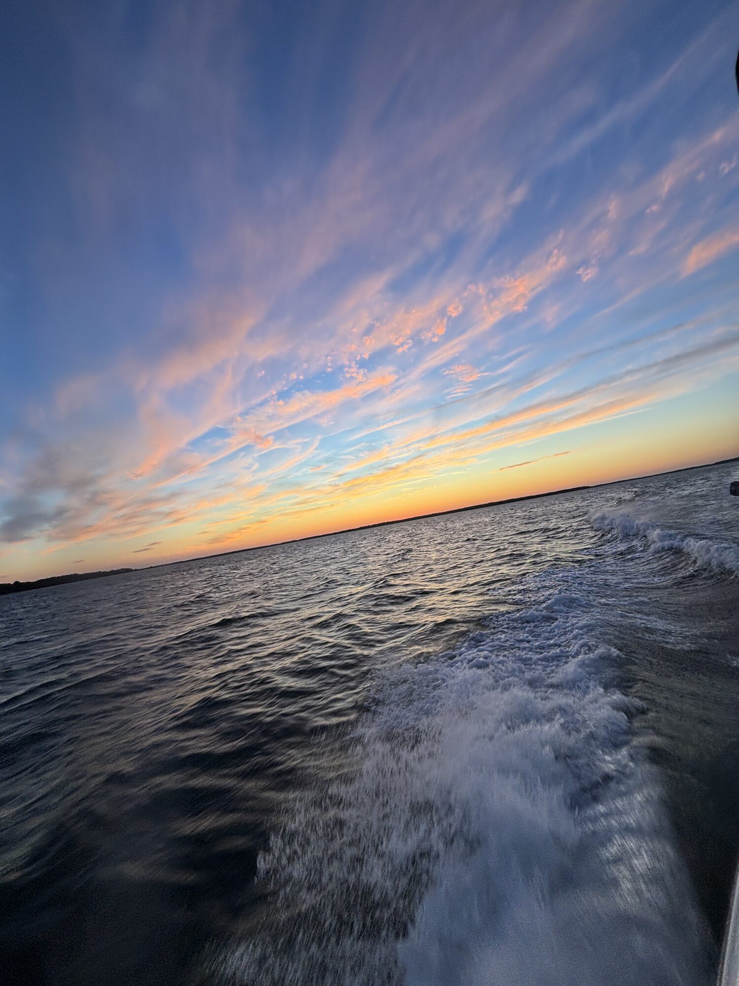 Wake and open sky at dusk in the Hamptons