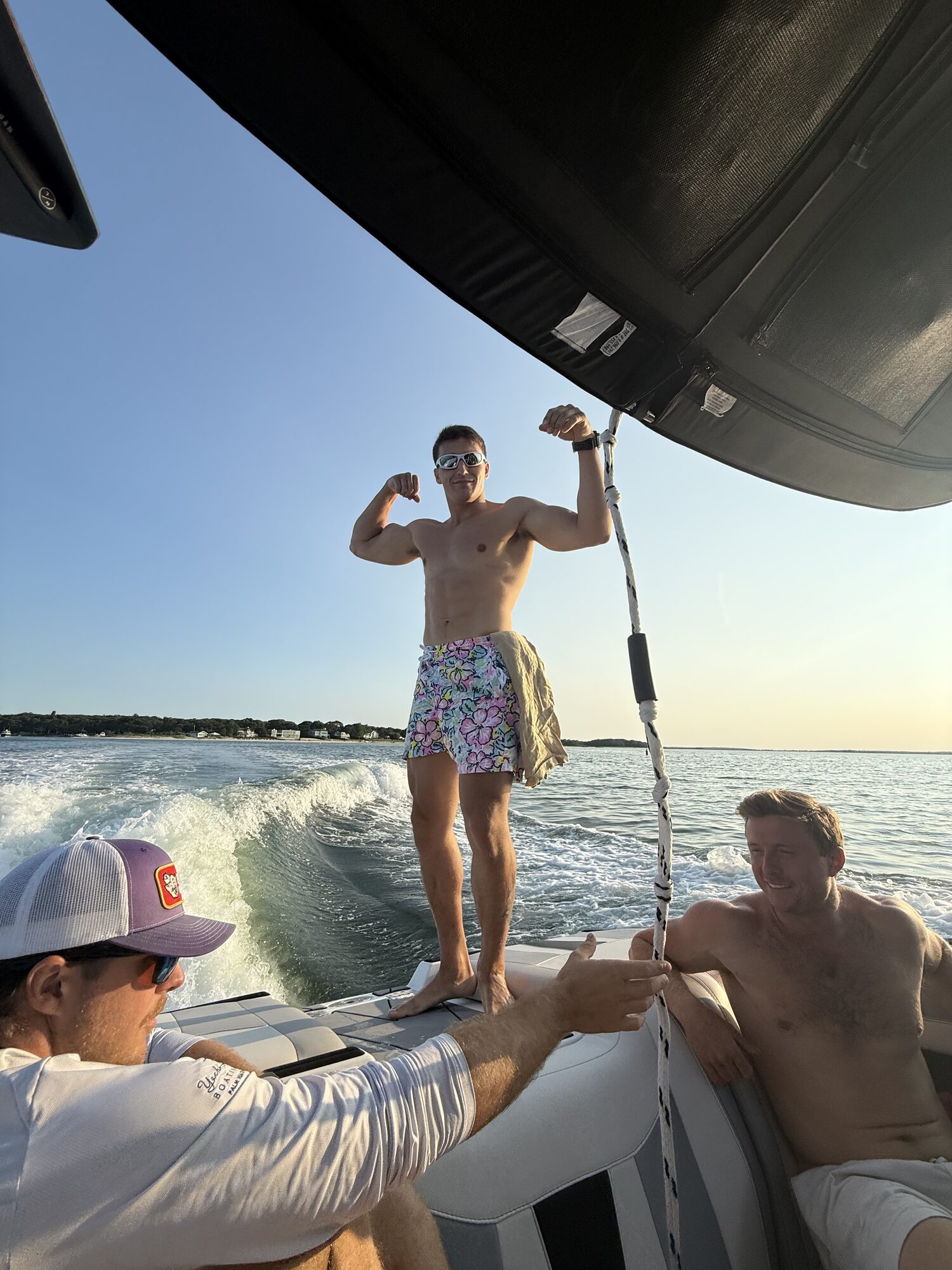 Wakesurfer riding the wake behind a Hamptons charter